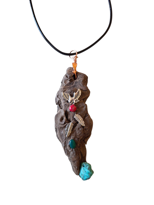 Necklace with a pendant shaped like a rock featuring a bird design on a white background